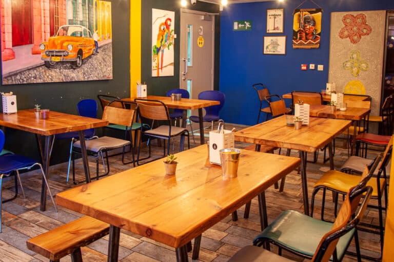 Inside The View Tube, warm tables and colourful Latin decor.