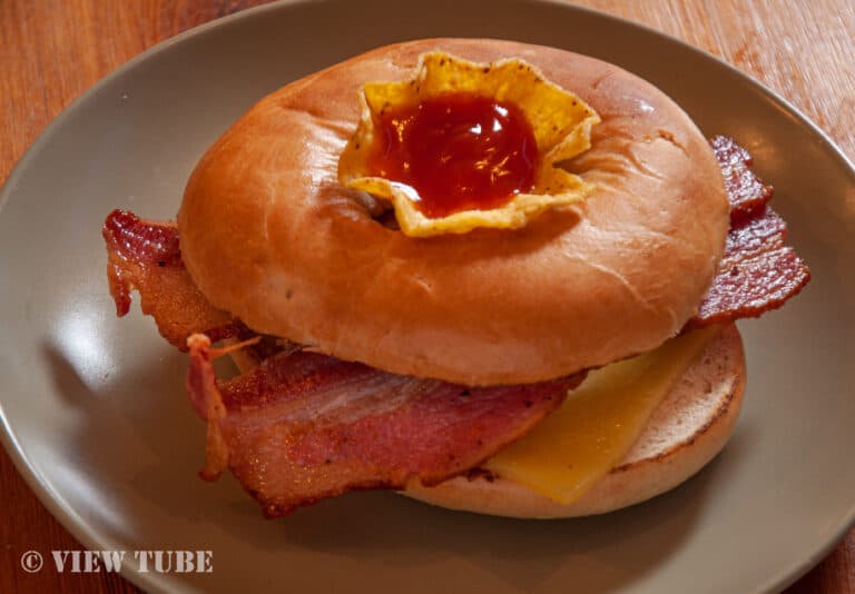 A toasted breakfast bagel filled with bacon, egg and cheese.